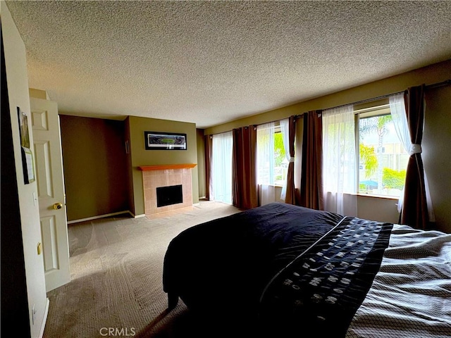 3381 Bandit Cir, Huntington Beach, CA 92649 - carpeted bedroom featuring a tiled fireplace and a textured ceiling