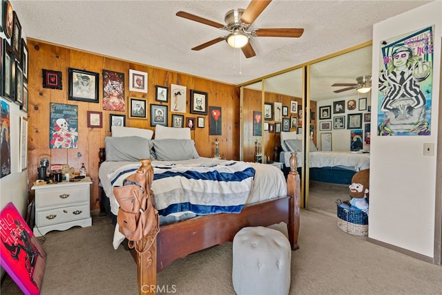 4271 Baggett Dr, Riverside, CA 92505 - bedroom featuring carpet flooring, a textured ceiling, wood walls, a closet, and ceiling fan