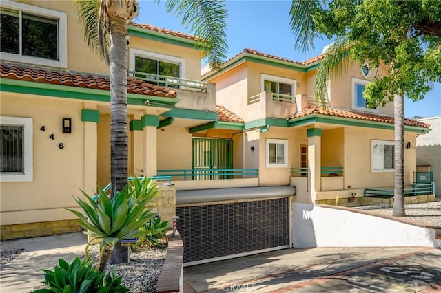 446 W Stocker St Unit 11, Glendale, CA 91202 - view of front facade featuring a balcony, a tiled roof, and stucco siding