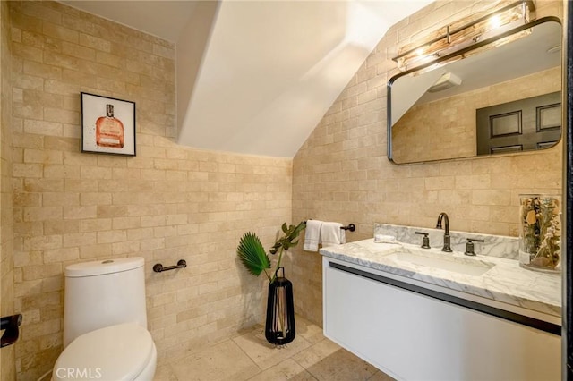 446 W Stocker St Unit 11, Glendale, CA 91202 - bathroom featuring toilet, vaulted ceiling, vanity, and tile patterned flooring