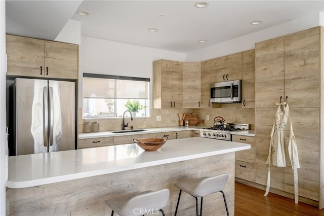 446 W Stocker St Unit 11, Glendale, CA 91202 - kitchen with appliances with stainless steel finishes, a sink, light countertops, tasteful backsplash, and recessed lighting