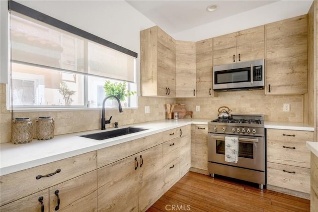 446 W Stocker St Unit 11, Glendale, CA 91202 - kitchen with stainless steel appliances, a sink, light brown cabinetry, and tasteful backsplash