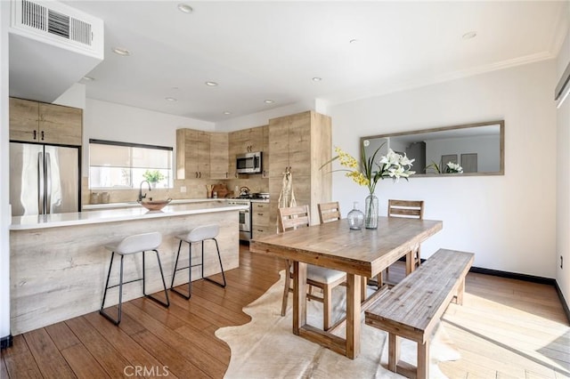 446 W Stocker St Unit 11, Glendale, CA 91202 - dining space with wood finished floors, recessed lighting, and crown molding