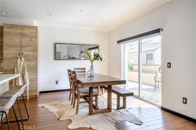 446 W Stocker St Unit 11, Glendale, CA 91202 - dining area featuring crown molding, baseboards, and wood finished floors