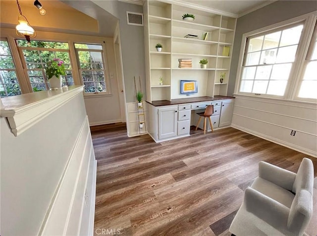 3275 N D St, San Bernardino, CA 92405 - home office featuring built in study area, crown molding, plenty of natural light, dark wood-style flooring, and baseboards