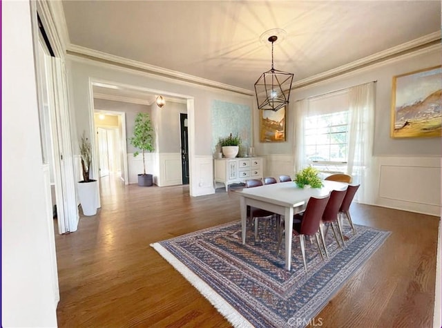 3275 N D St, San Bernardino, CA 92405 - dining space featuring a decorative wall, crown molding, wainscoting, dark wood-type flooring, and a chandelier