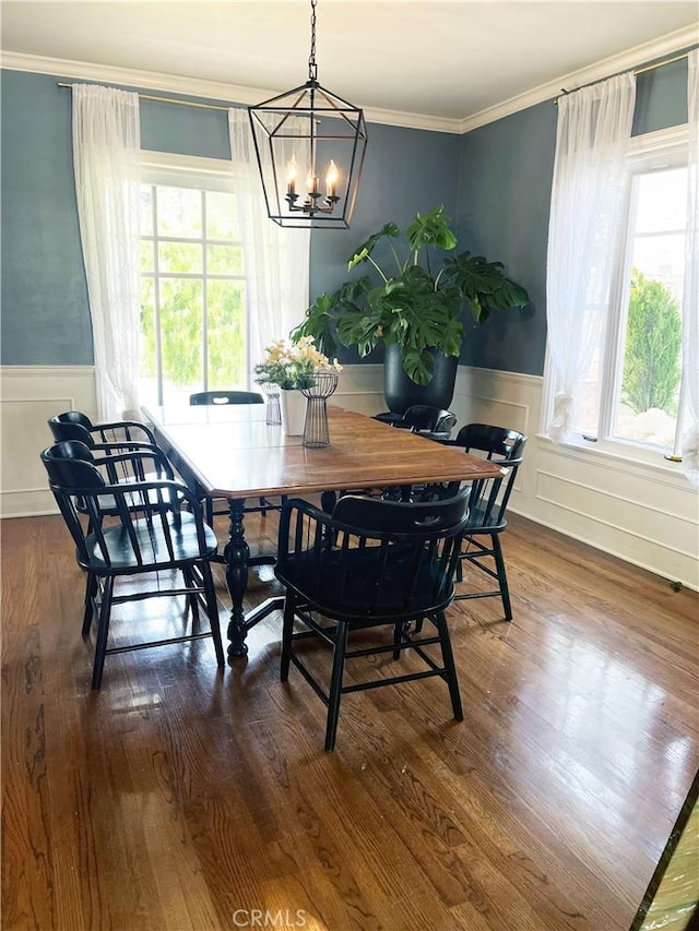3275 N D St, San Bernardino, CA 92405 - dining space with a chandelier, wainscoting, crown molding, dark wood finished floors, and a decorative wall