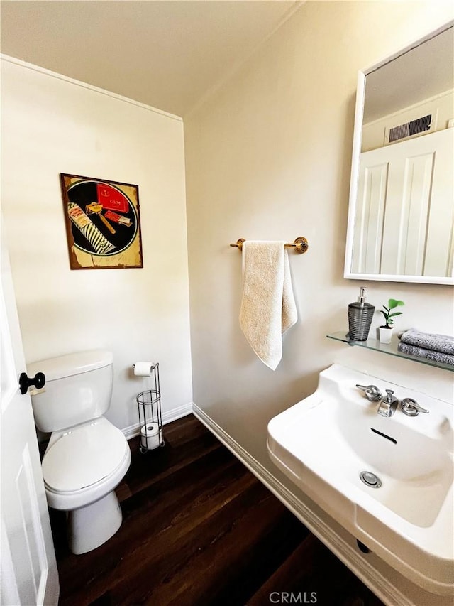 3275 N D St, San Bernardino, CA 92405 - bathroom with wood finished floors, toilet, baseboards, and a sink