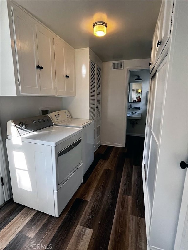 3275 N D St, San Bernardino, CA 92405 - laundry area with cabinet space, washer and clothes dryer, and dark wood-type flooring