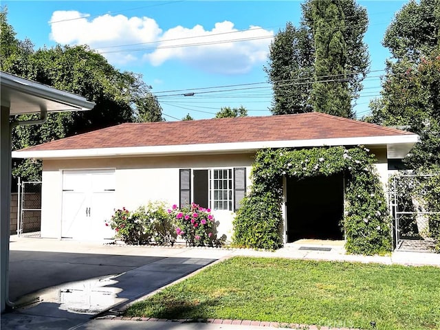 3275 N D St, San Bernardino, CA 92405 - view of front of house featuring roof with shingles, a garage, and stucco siding
