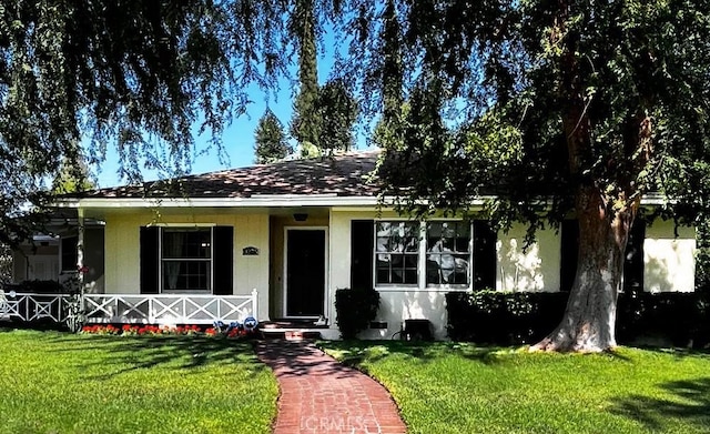 3275 N D St, San Bernardino, CA 92405 - view of front of house featuring a front lawn, a porch, and stucco siding