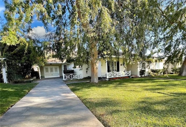 3275 N D St, San Bernardino, CA 92405 - view of front of house featuring concrete driveway, a front lawn, and covered porch