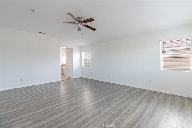 38161 Desert Hawk Dr, Palmdale, CA 93552 - unfurnished room with a ceiling fan, lofted ceiling, wood finished floors, baseboards, and a smoke detector