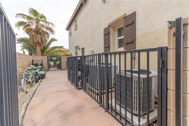 38161 Desert Hawk Dr, Palmdale, CA 93552 - view of patio featuring central AC unit and a gate