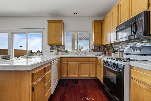 3065 Conestoga Canyon Rd, Palmdale, CA 93550 - kitchen with black appliances, tile counters, a peninsula, dark wood-type flooring, and recessed lighting