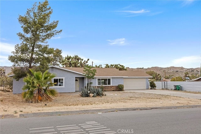 7010 Airway Ave, Yucca Valley, CA 92284 - single story home featuring driveway, stucco siding, a garage, and a mountain view