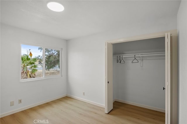 7010 Airway Ave, Yucca Valley, CA 92284 - unfurnished bedroom featuring light wood-type flooring, a closet, and baseboards