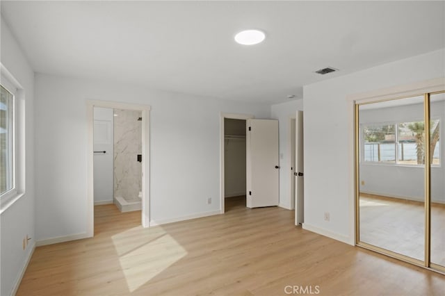 7010 Airway Ave, Yucca Valley, CA 92284 - unfurnished bedroom with light wood finished floors, baseboards, and connected bathroom