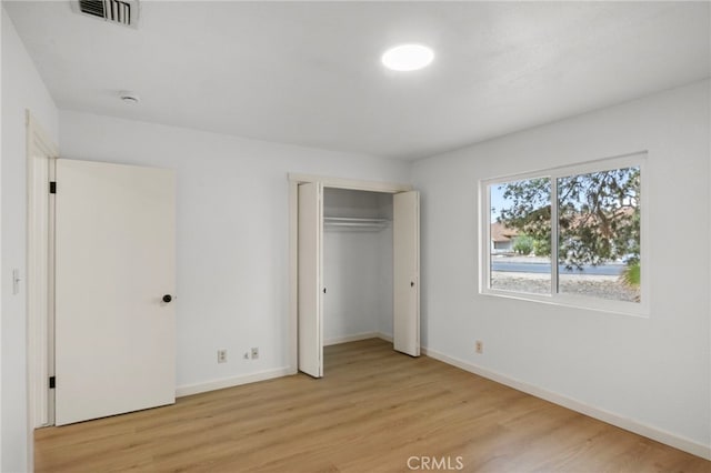 7010 Airway Ave, Yucca Valley, CA 92284 - unfurnished bedroom featuring light wood-type flooring, baseboards, and a closet