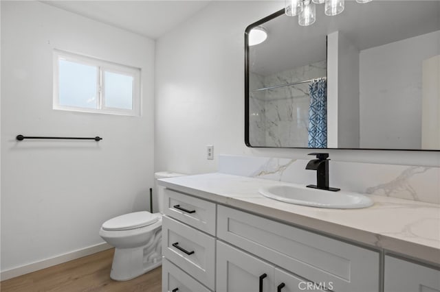 7010 Airway Ave, Yucca Valley, CA 92284 - bathroom featuring vanity, toilet, wood finished floors, baseboards, and a shower with shower curtain