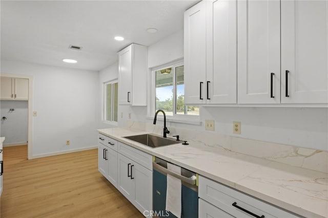 7010 Airway Ave, Yucca Valley, CA 92284 - kitchen with a sink, dishwasher, light wood finished floors, light stone counters, and baseboards