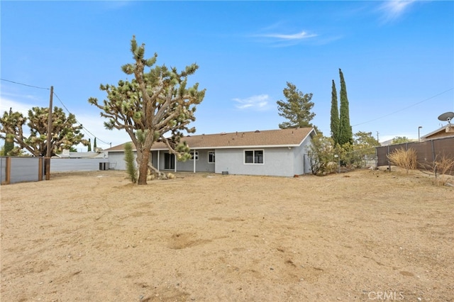 7010 Airway Ave, Yucca Valley, CA 92284 - rear view of house with a fenced backyard and stucco siding
