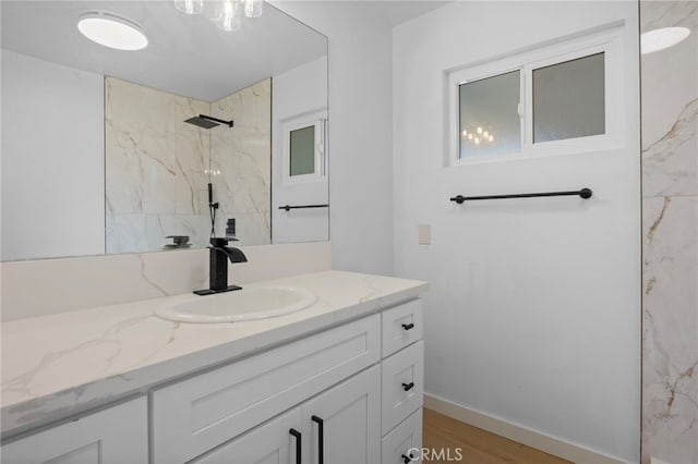7010 Airway Ave, Yucca Valley, CA 92284 - bathroom featuring vanity, a marble finish shower, wood finished floors, and baseboards