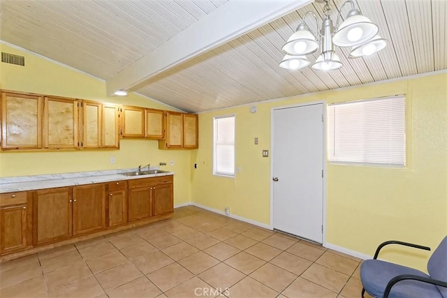 15521 Heartsease Ln, Victorville, CA 92395 - kitchen featuring a sink, light countertops, a chandelier, light tile patterned floors, and baseboards