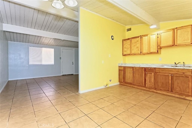 15521 Heartsease Ln, Victorville, CA 92395 - kitchen featuring a sink, light tile patterned floors, light countertops, baseboards, and wooden ceiling