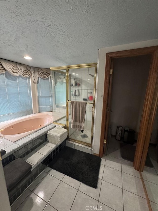 9322 Candlelight St, Apple Valley, CA 92308 - bathroom with a whirlpool tub, a stall shower, tile patterned flooring, and a textured ceiling