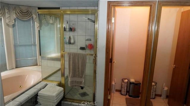 9322 Candlelight St, Apple Valley, CA 92308 - bathroom featuring a shower stall, a tub with jets, and tile patterned flooring