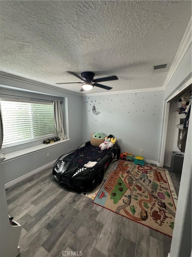 9322 Candlelight St, Apple Valley, CA 92308 - bedroom featuring a textured ceiling, wood finished floors, crown molding, and a ceiling fan