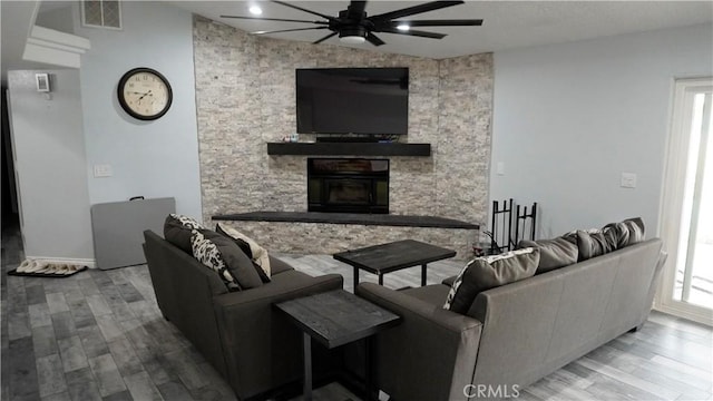 9322 Candlelight St, Apple Valley, CA 92308 - living area with ceiling fan, a fireplace, wood finished floors, and healthy amount of natural light