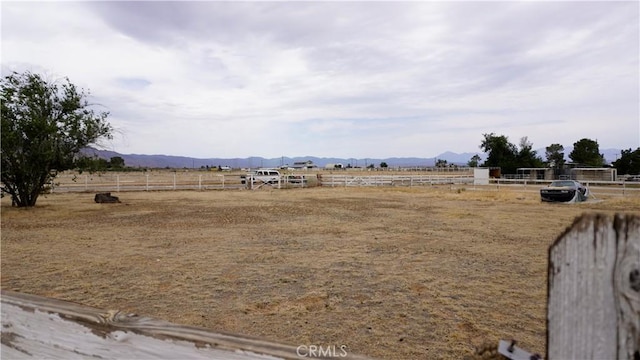 9322 Candlelight St, Apple Valley, CA 92308 - view of yard with a mountain view, an enclosed riding area, and a view of countryside