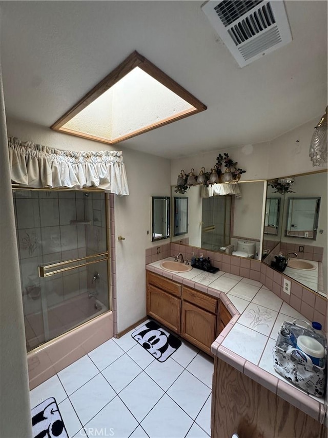 9322 Candlelight St, Apple Valley, CA 92308 - bathroom with vanity, tile patterned floors, tasteful backsplash, and a skylight