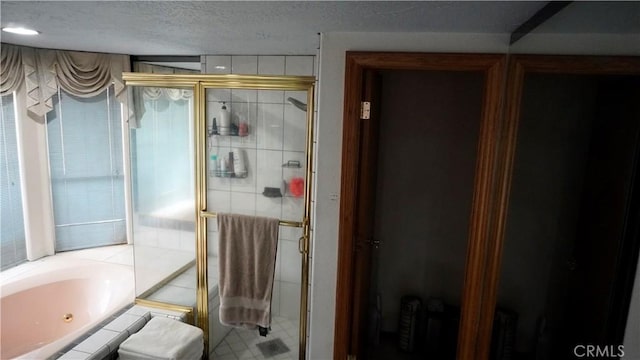 9322 Candlelight St, Apple Valley, CA 92308 - bathroom featuring a shower stall, a garden tub, and a textured ceiling