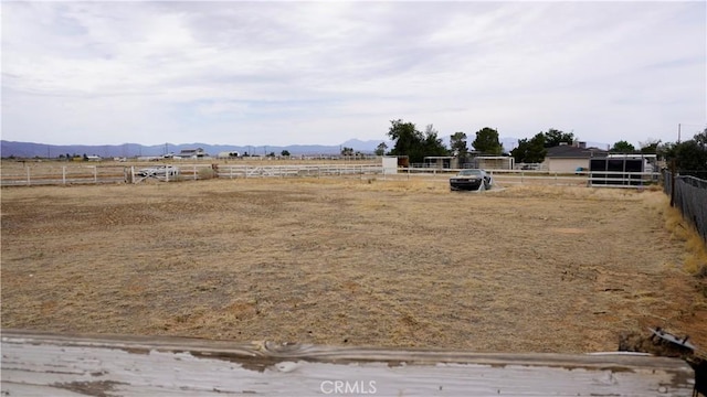 9322 Candlelight St, Apple Valley, CA 92308 - view of yard with an outdoor riding arena, a mountain view, and a view of rural / pastoral area