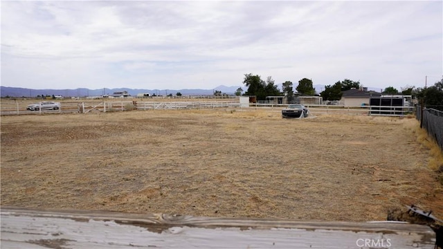 9322 Candlelight St, Apple Valley, CA 92308 - view of yard with a mountain view, an enclosed horse arena, and a view of countryside