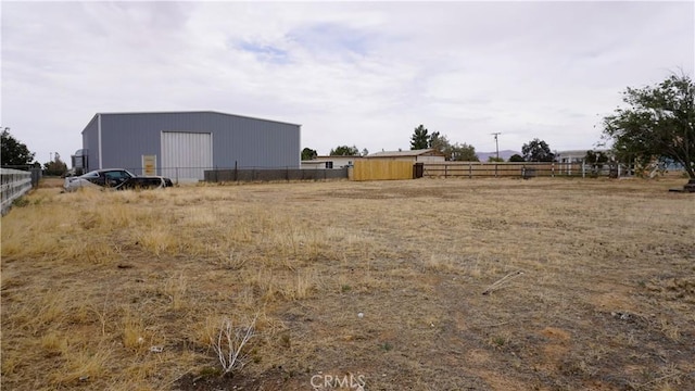 9322 Candlelight St, Apple Valley, CA 92308 - view of yard with an outdoor structure, an outbuilding, and a detached garage