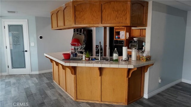 9322 Candlelight St, Apple Valley, CA 92308 - kitchen featuring tile counters, baseboards, and wood finished floors