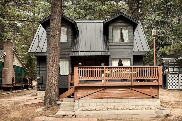 664 Yukon Rd, Green Valley Lake, CA 92341 - back of property with metal roof, a wooden deck, and view of scattered trees