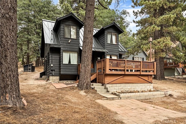 664 Yukon Rd, Green Valley Lake, CA 92341 - back of property with a deck, metal roof, and stairs