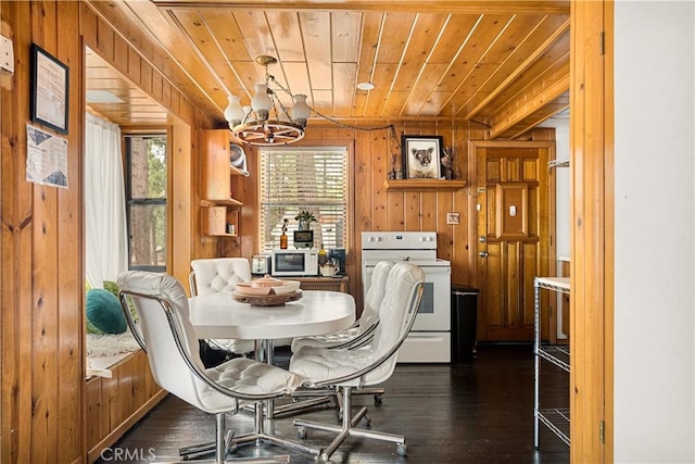 664 Yukon Rd, Green Valley Lake, CA 92341 - dining space with plenty of natural light, wooden walls, a chandelier, wood ceiling, and dark wood-style flooring