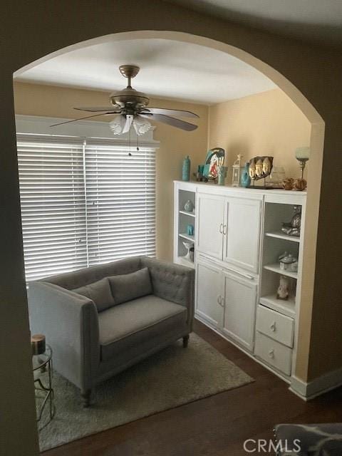 1322 E 70th St E, Los Angeles, CA 90001 - sitting room featuring a ceiling fan, arched walkways, and dark wood-type flooring