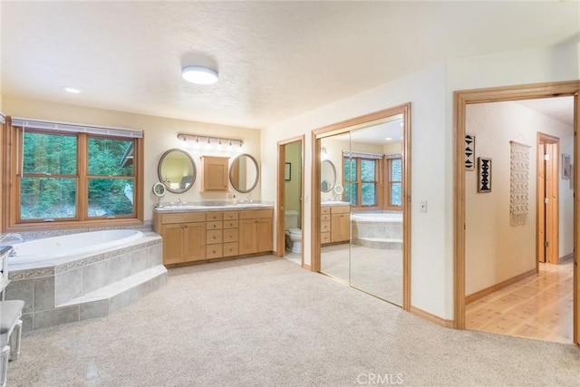 1900 Maple Dr, Weed, CA 96094 - bathroom featuring double vanity, a bath, healthy amount of natural light, and carpet