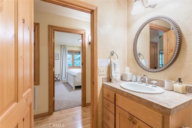 1900 Maple Dr, Weed, CA 96094 - ensuite bathroom with wood finished floors, vanity, and a textured wall