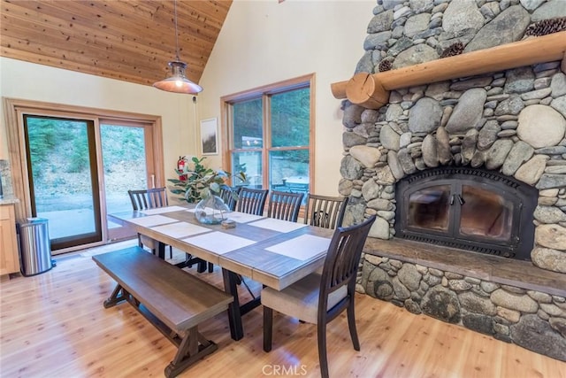 1900 Maple Dr, Weed, CA 96094 - dining area featuring high vaulted ceiling, a stone fireplace, light wood-style floors, and wooden ceiling