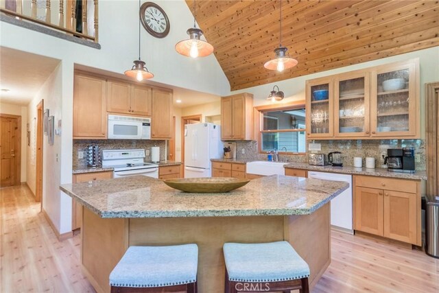 1900 Maple Dr, Weed, CA 96094 - kitchen featuring white appliances, a sink, light wood-style flooring, a kitchen island, and high vaulted ceiling
