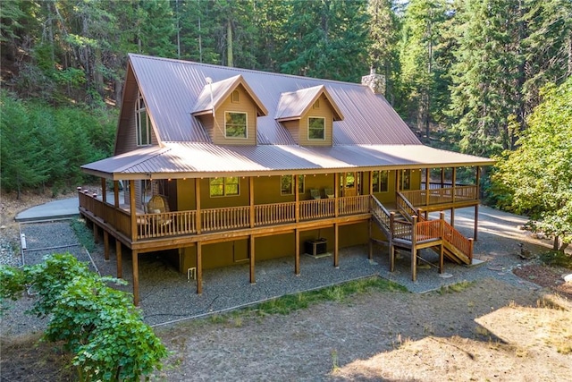 1900 Maple Dr, Weed, CA 96094 - back of house featuring a forest view, metal roof, covered porch, and a chimney