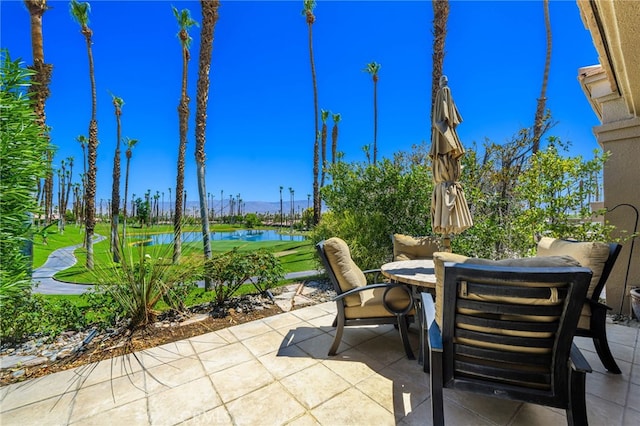 76022 Honeysuckle Dr, Palm Desert, CA 92211 - view of patio featuring outdoor dining space and a water view
